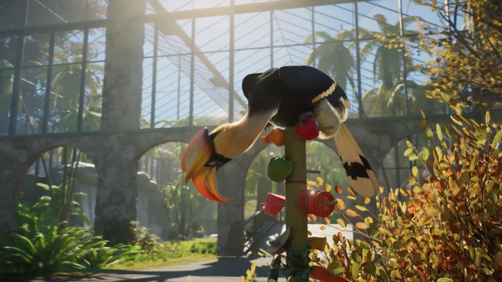 Great Hornbill feeding from a hanging fruit enrichment station inside a covered Planet Zoo 2 aviary